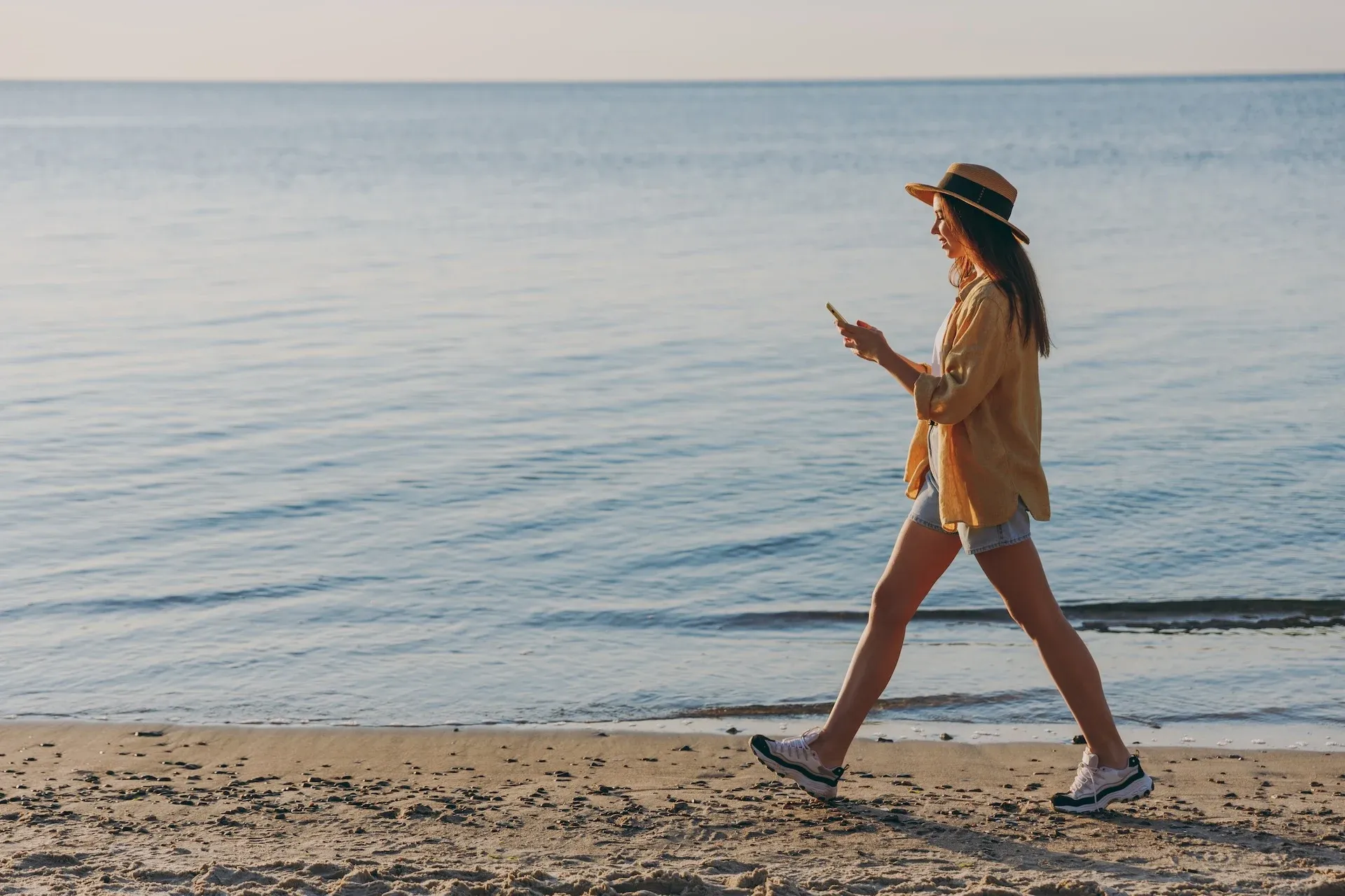 Woman walking down the beach 